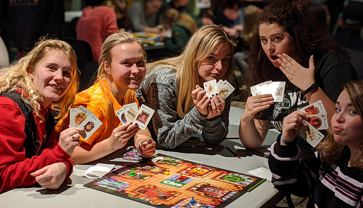 Students playing Clue board game during Game Night in WU